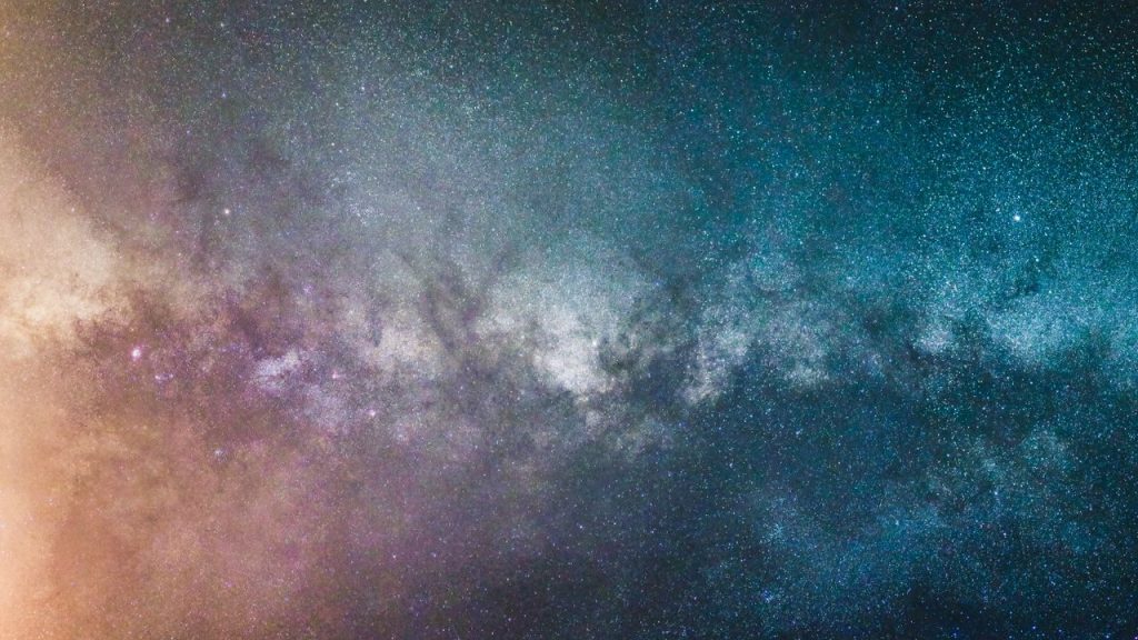 Stunning view of the Milky Way galaxy at night, showcasing countless stars and cosmic colors.